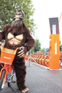 Sasquatch riding his BIKETOWN in Downtown Portland.