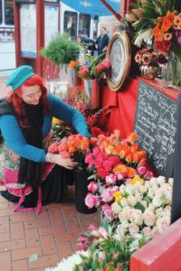 Local business owner prepping her flower stand in downtown.